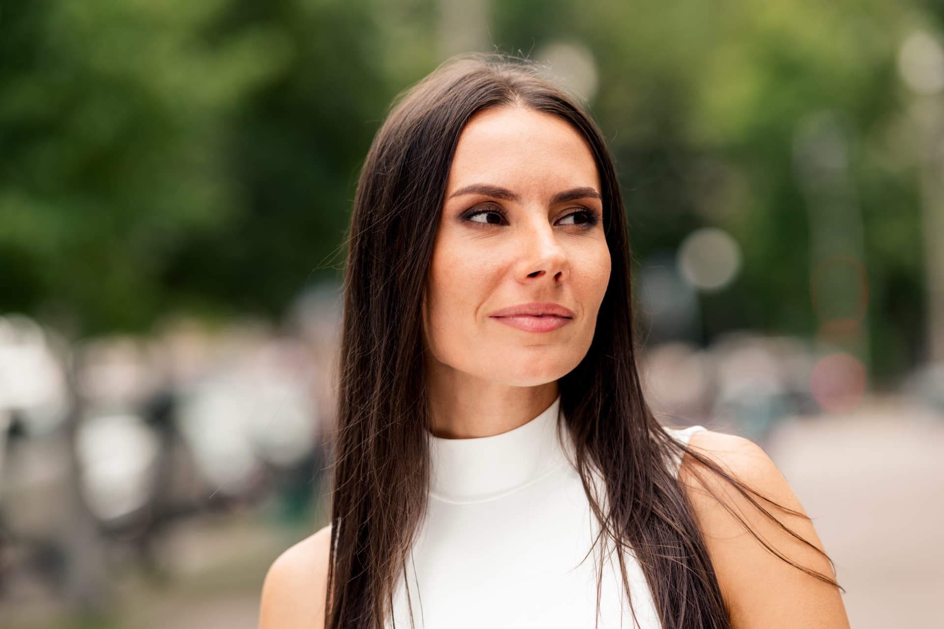 A woman looking calmly into the middle distance.
