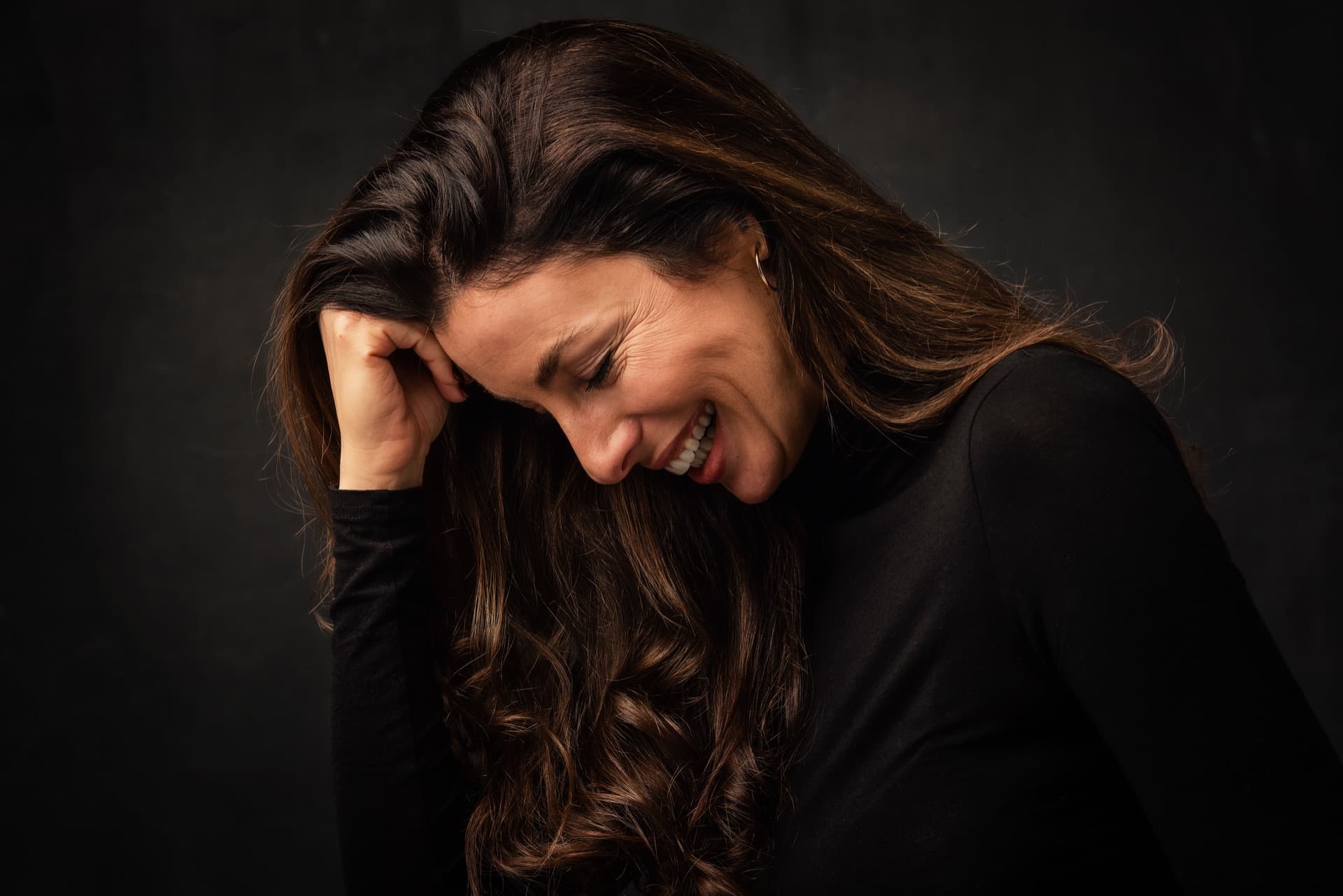 A woman in warm light, at ease with herself.